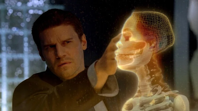 Booth feeling a holographic skeleton on Bones