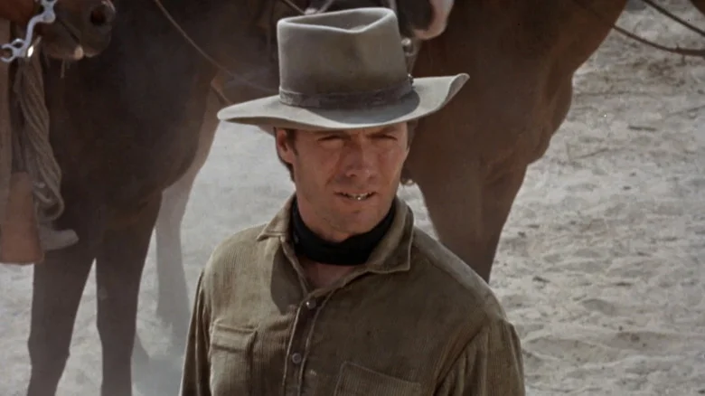 Clint Eastwood's Jed Cooper  stands in front of a horse in Hang 'Em High