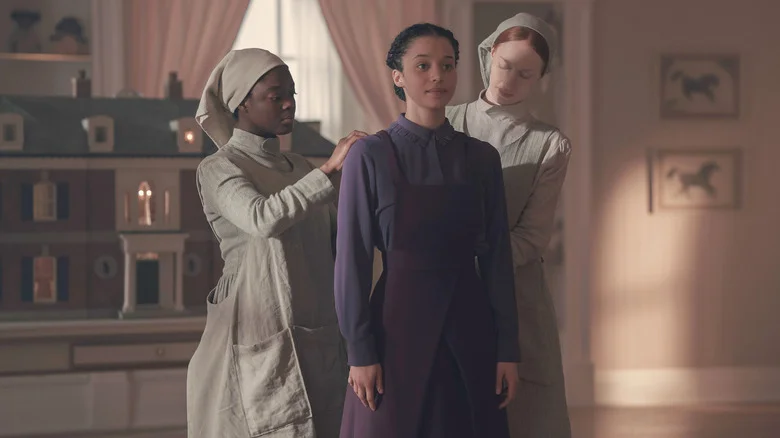 Agnes being dressed by two Marthas in The Testaments