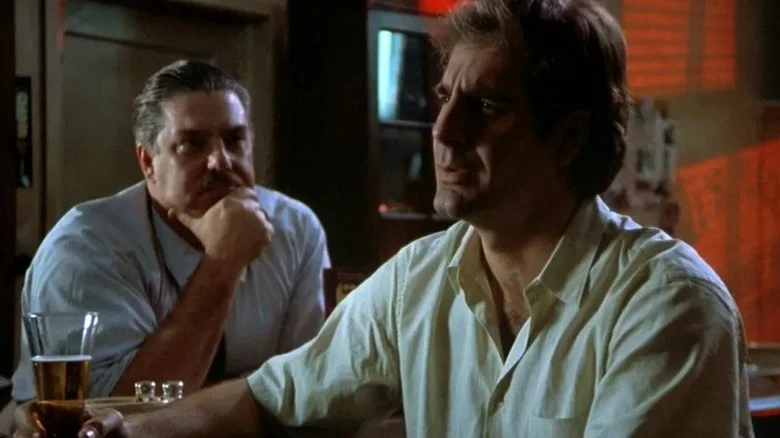 Al (Bruce McGill) watches Sam Beckett (Scott Bakula) intently at a bar in Quantum Leap (1989)